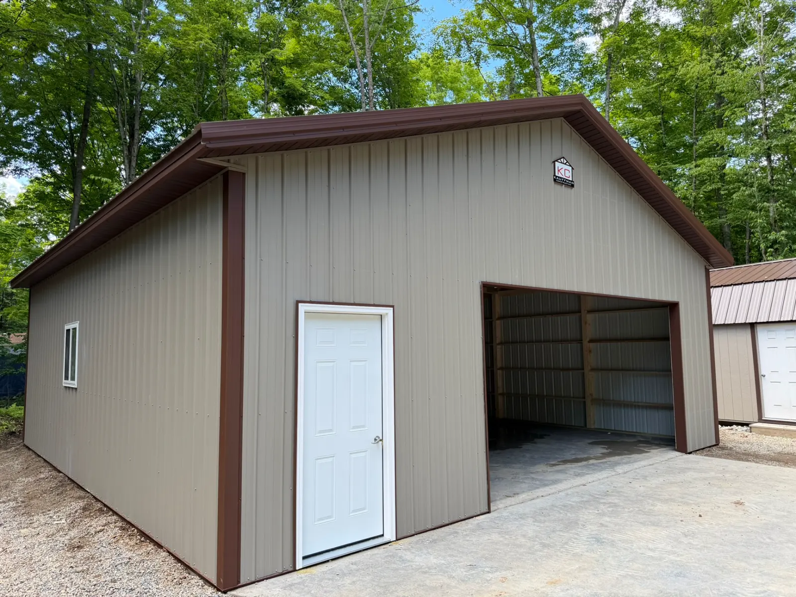 Detached pole garage with brown trim and concrete apron, built by Kauffman Construction in Wisconsin