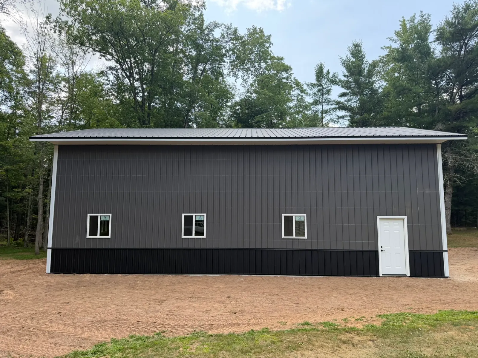 Dark gray pole building sidewall with black wainscot, built by Kauffman Construction in Wisconsin