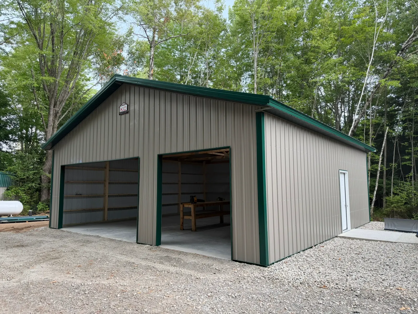 Two-stall pole garage with green trim, built by Kauffman Construction in Wisconsin