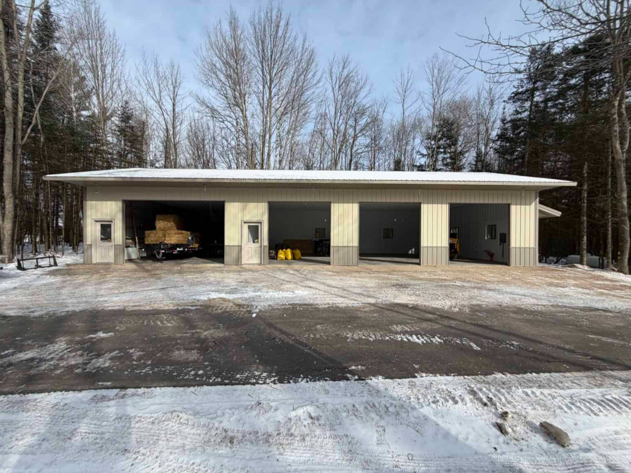 Large post-frame building in a wooded Wisconsin setting