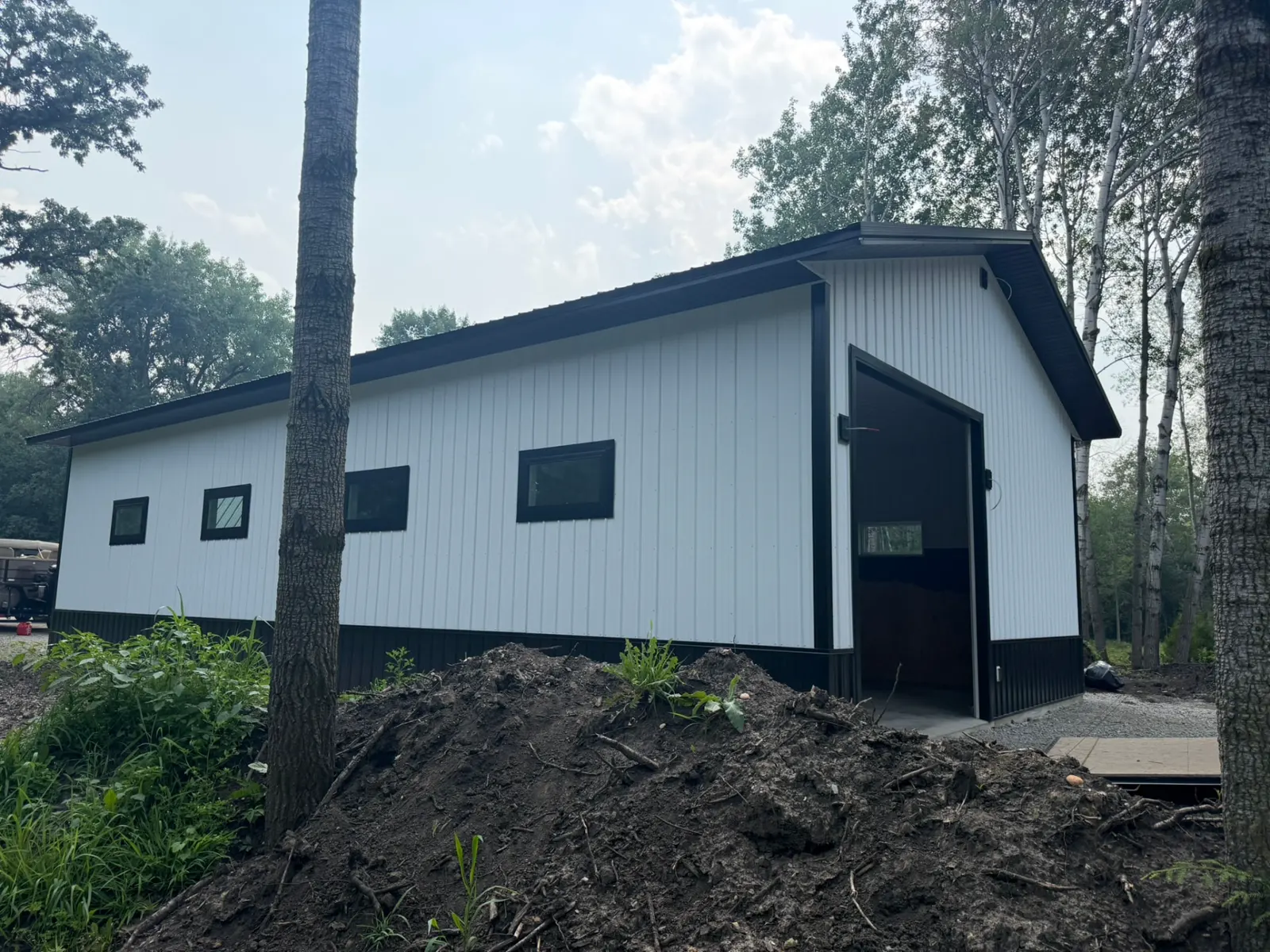 White pole garage with black trim and windows, built by Kauffman Construction in Wisconsin